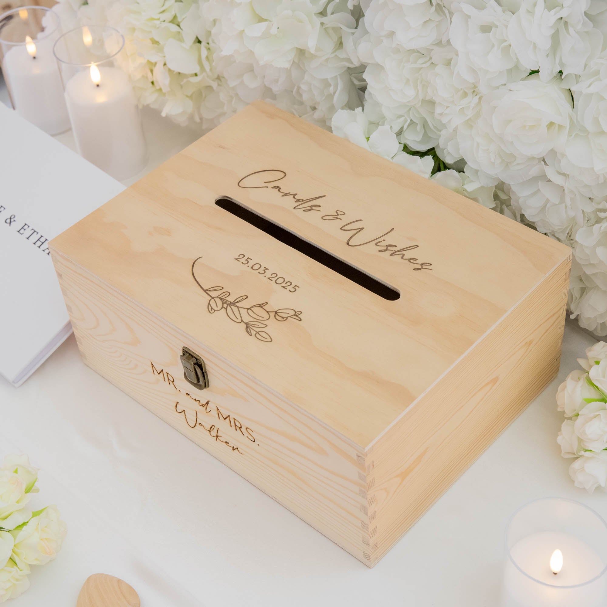 Wooden card box with engraved text on a floral background