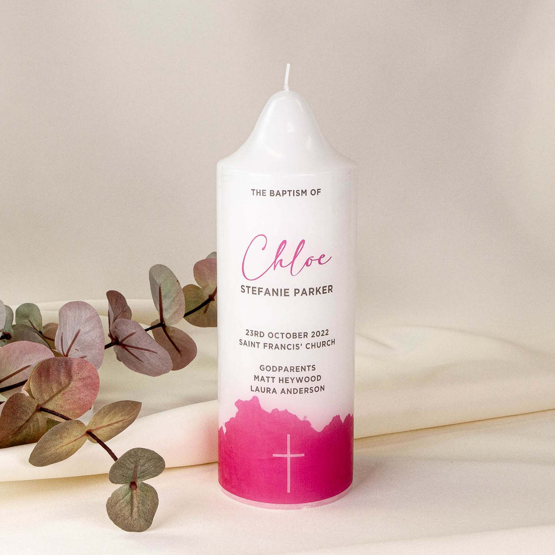 Personalised baptism candle with hot pink pattern and cross. It says "Chloe STEFANIE PARKER" , and other details such as baptism date, name of the church and godparents name